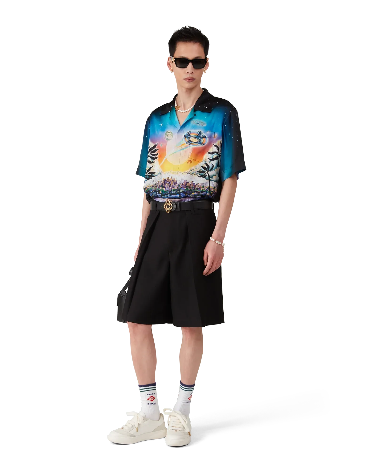 Model styling black wool pleated shorts with tailored casualwear