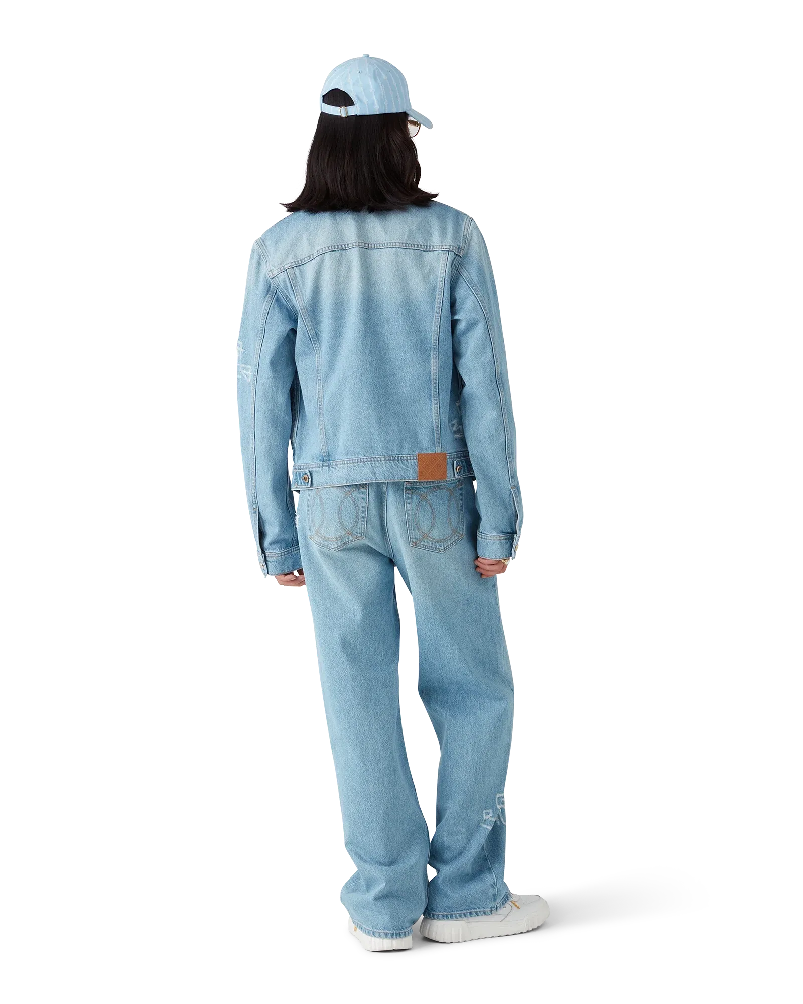 Model wearing Light Blue Graffiti Distressed Denim Jacket in vintage wash with relaxed fit