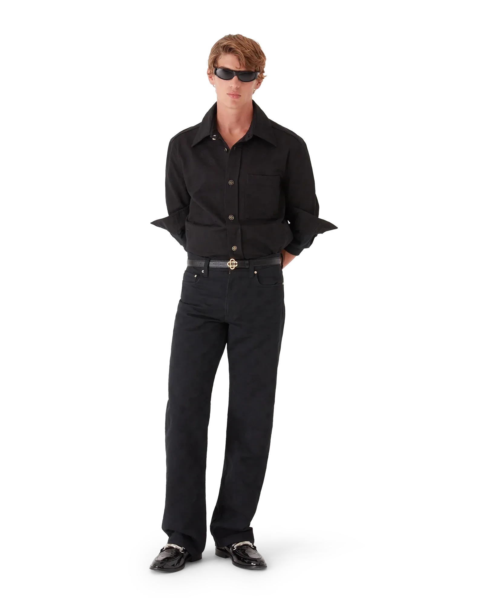 : Close-up of interlocking CC logo gold-plated button and hardware on Black Denim Monogram Straight-Leg Jeans